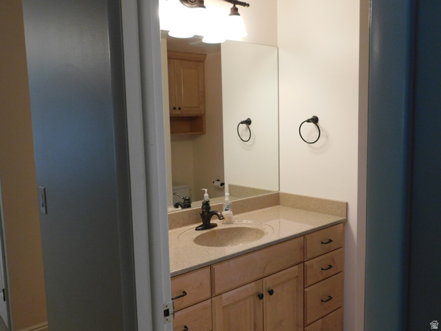 2148 Carolyn Way Bountiful, UT 84010 - Photo 11 of 40 Bathroom featuring a single vanity with light-toned cabinetry, a built-in sink, and a light-colored countertop