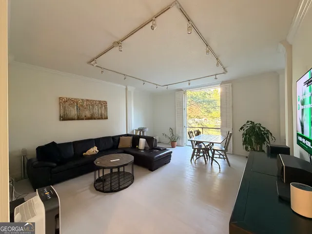 a living room with furniture wooden floor and a table