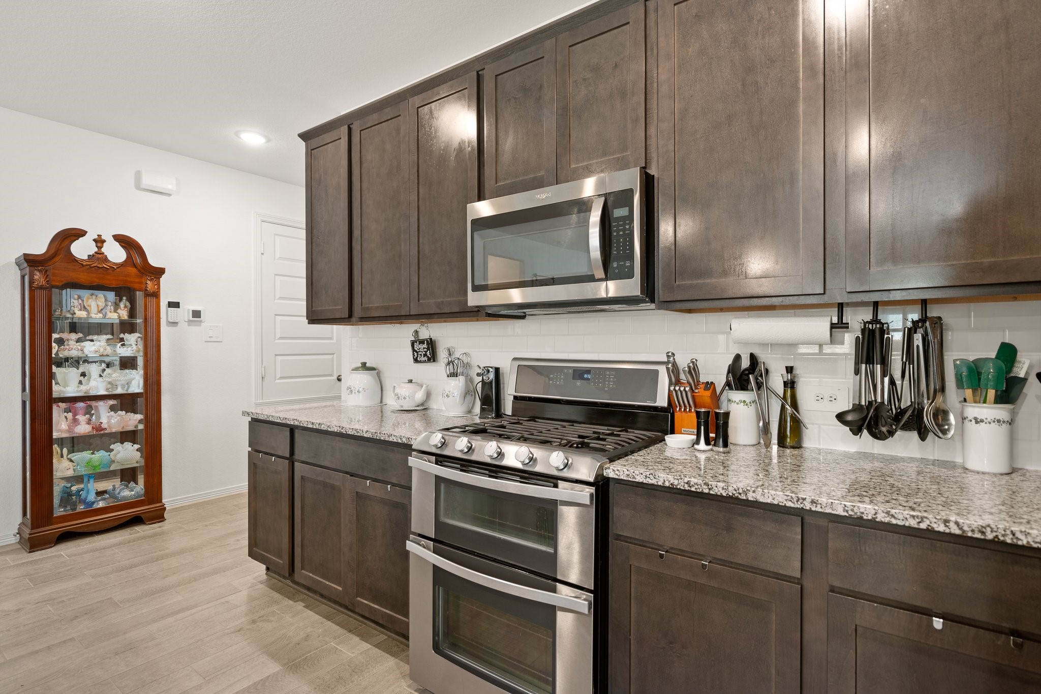 14449 Sunny Bend Way Conroe, TX 77303 - Photo 8 of 25 a kitchen with granite countertop a stove and a sink