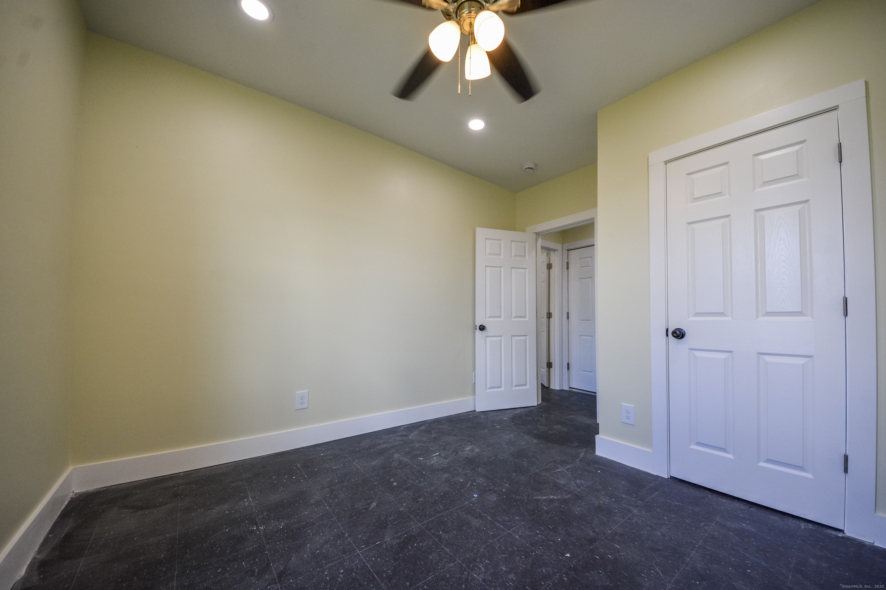 92 High Street, Unit 4W Waterbury, CT 06704 - Photo 11 of 22 an empty room with a ceiling fan and a window
