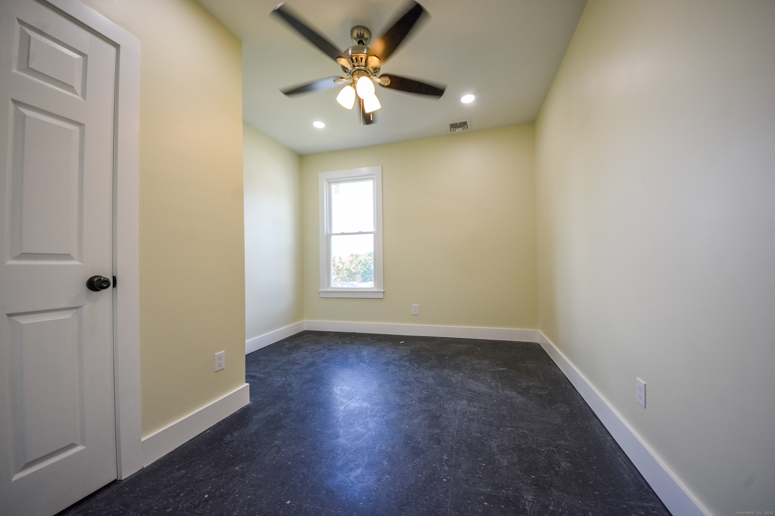 92 High Street, Unit 4W Waterbury, CT 06704 - Photo 13 of 22 an empty room with wooden floor and windows