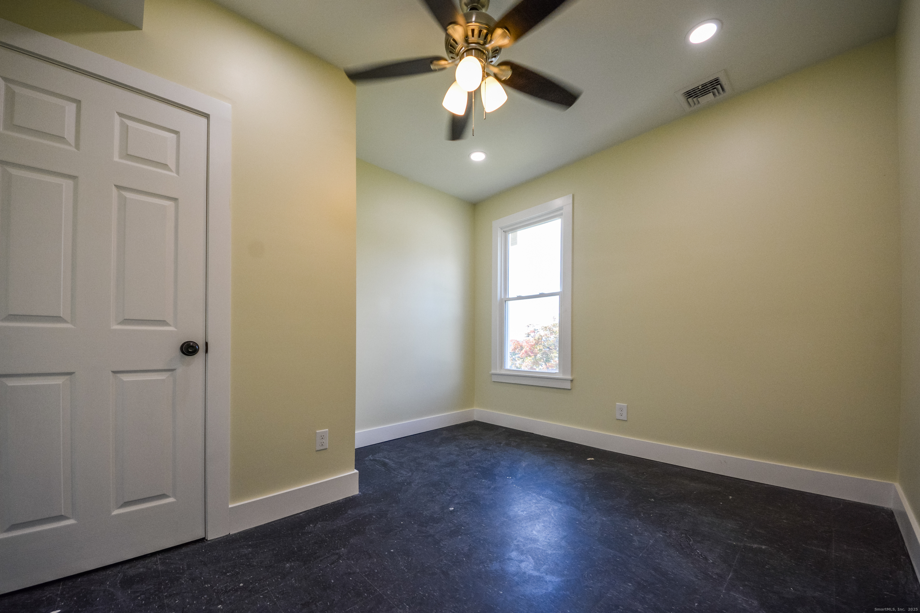 92 High Street, Unit 4W Waterbury, CT 06704 - Photo 14 of 22 an empty room with wooden floor chandelier fan and windows