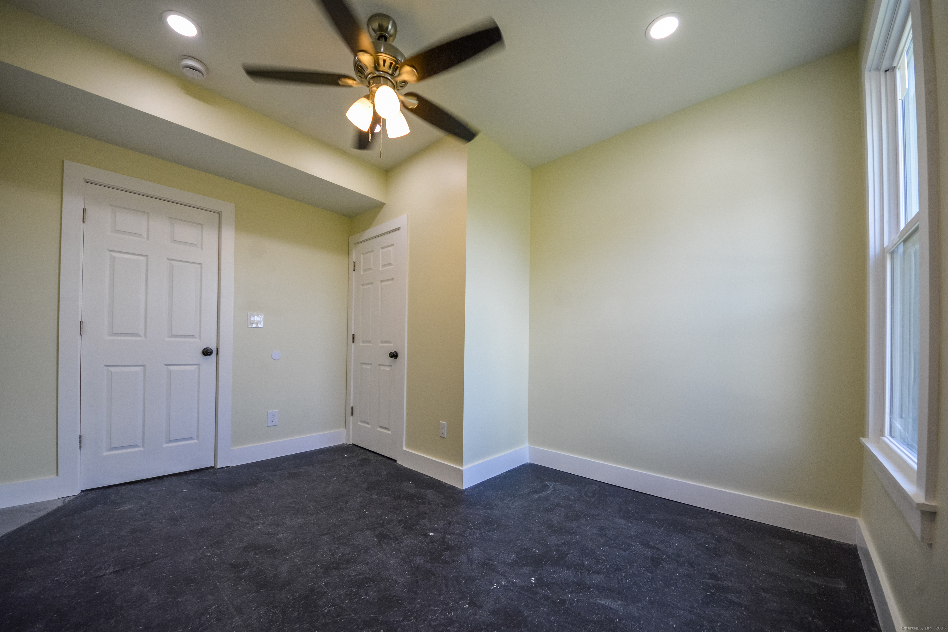 92 High Street, Unit 4W Waterbury, CT 06704 - Photo 15 of 22 an empty room with a ceiling fan and a window