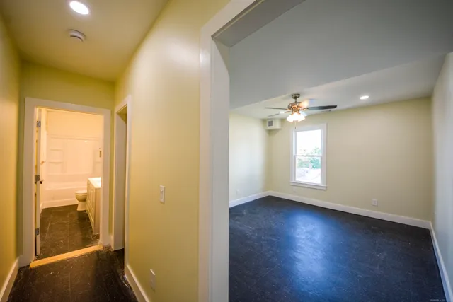 an empty room with windows and closet