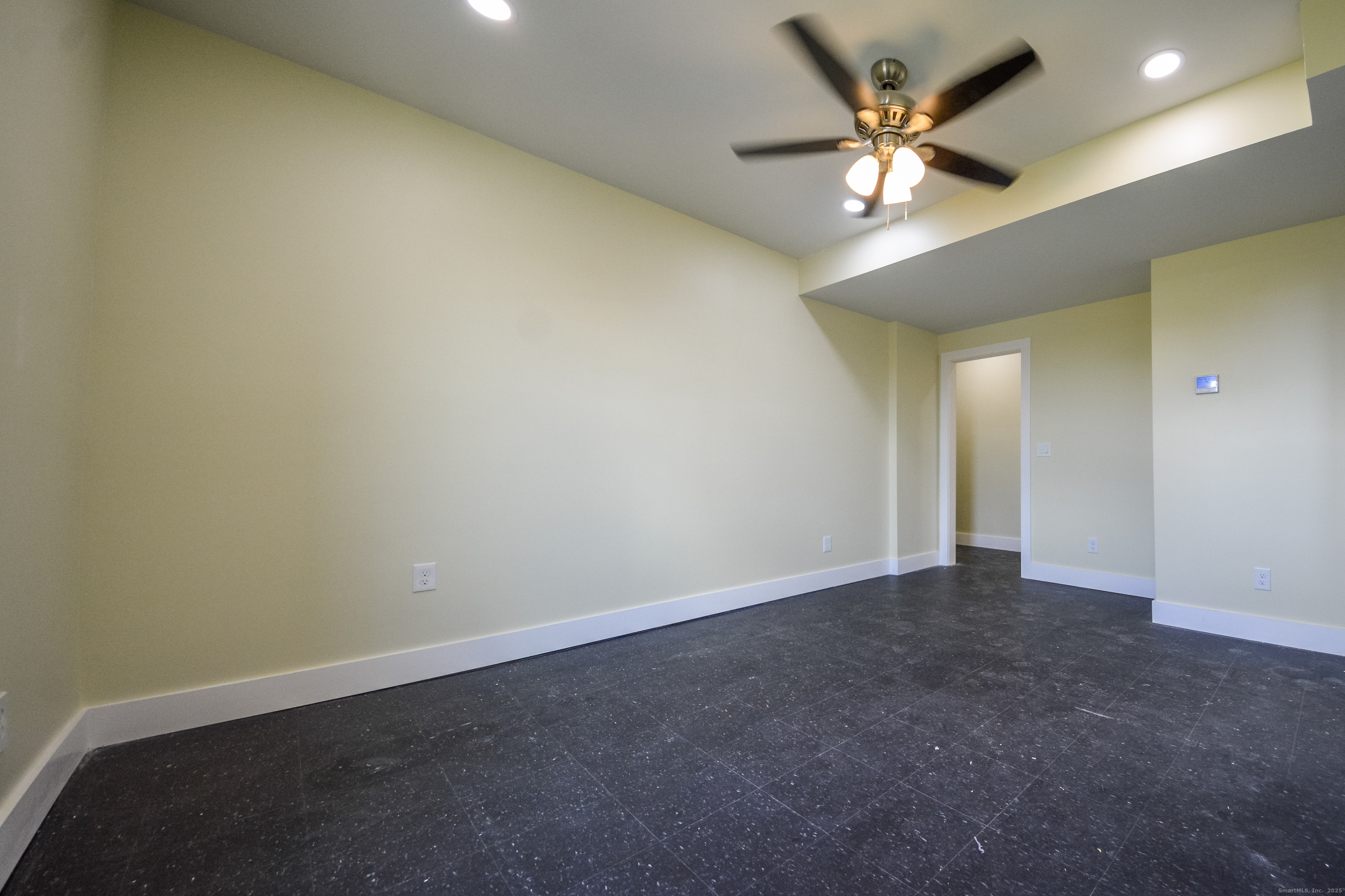 92 High Street, Unit 4W Waterbury, CT 06704 - Photo 20 of 22 an empty room with a ceiling fan and a fan