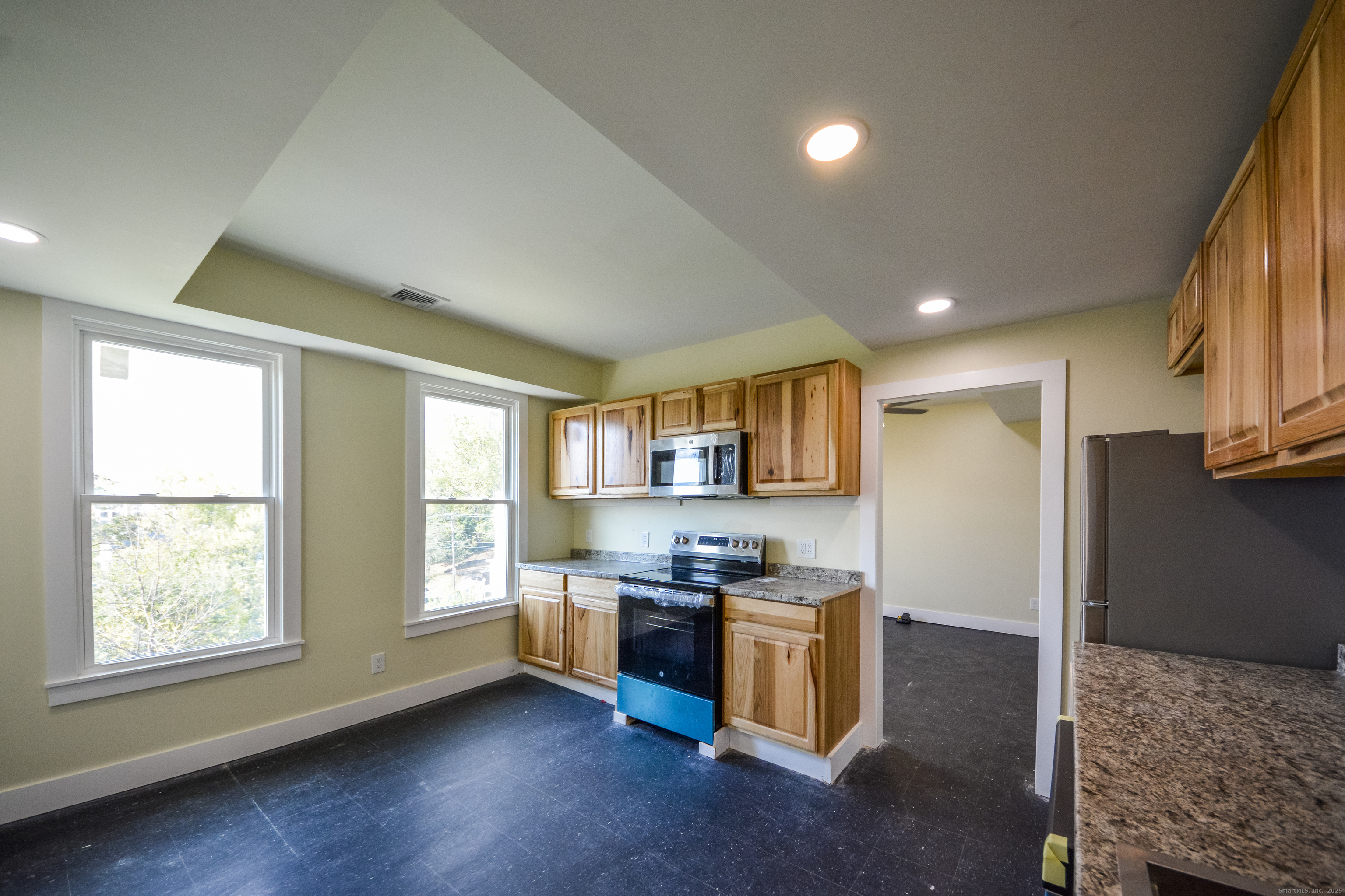 92 High Street, Unit 4W Waterbury, CT 06704 - Photo 2 of 22 a kitchen with stainless steel appliances granite countertop a refrigerator and a sink