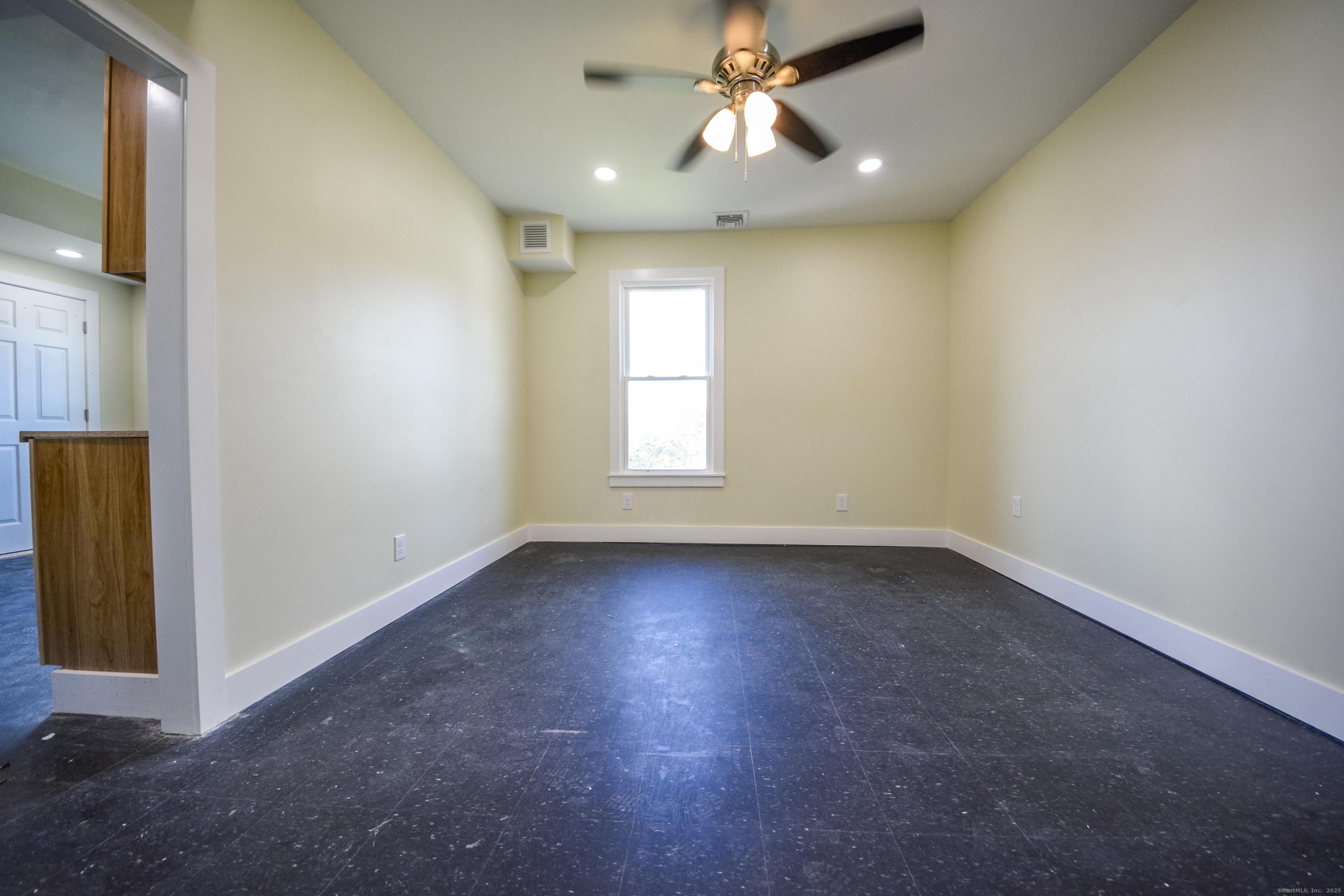 92 High Street, Unit 4W Waterbury, CT 06704 - Photo 21 of 22 an empty room with a window and a fan