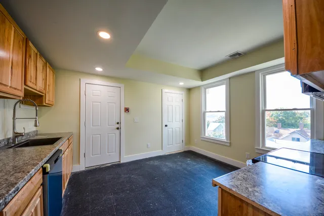 a view of a kitchen cabinets a sink and wooden floor