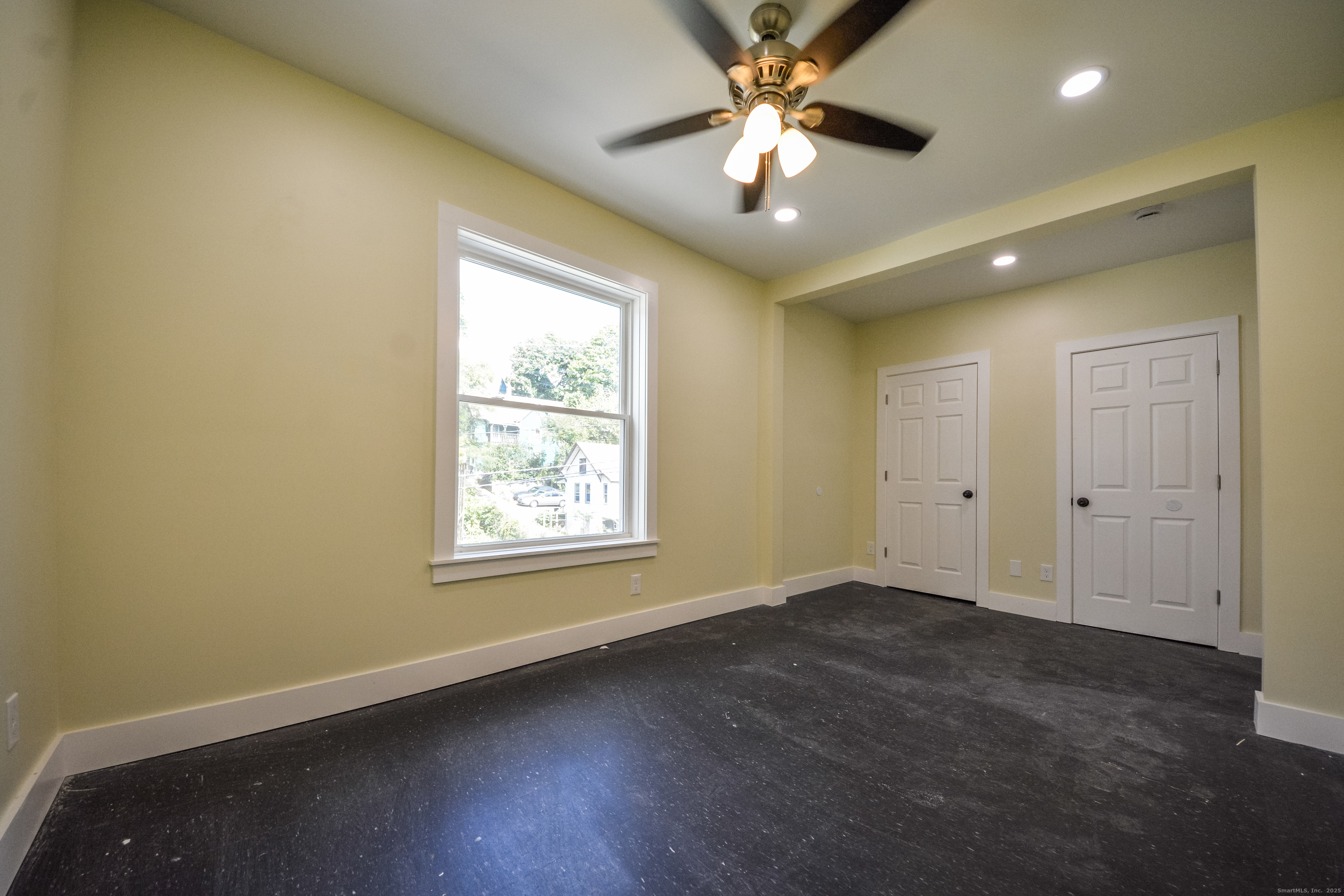 92 High Street, Unit 4W Waterbury, CT 06704 - Photo 5 of 22 an empty room with wooden floor and windows