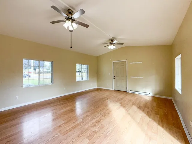 an empty room with windows and closet