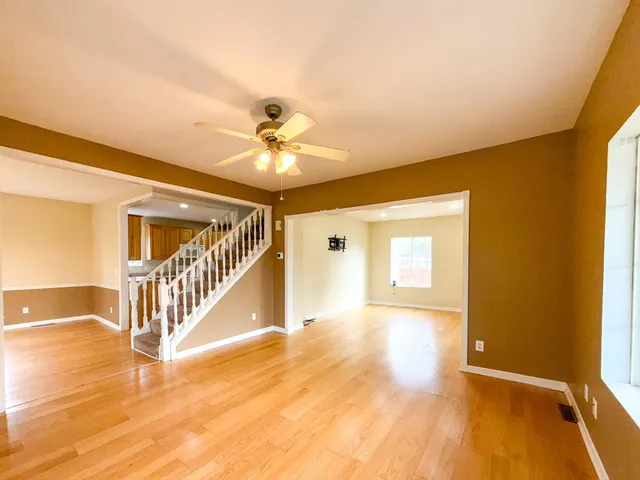 a view of a livingroom with a hall and wooden floor