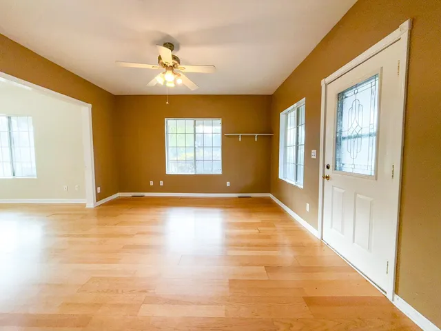 a view of an empty room with glass door