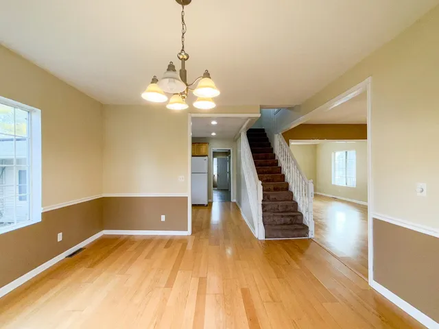 a kitchen with a refrigerator sink stove and cabinets