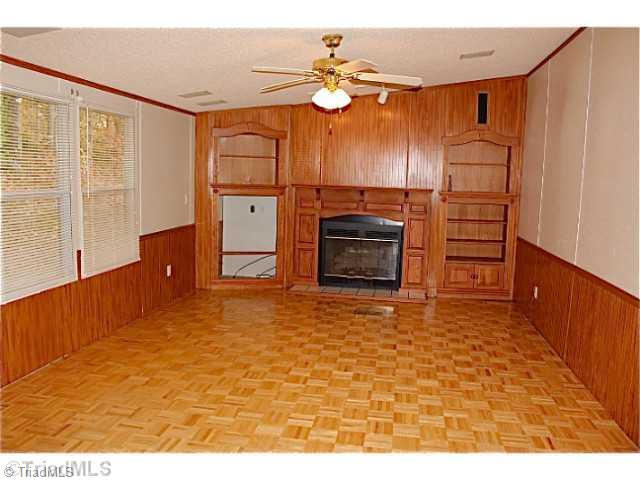 3846 Earnhardt Road Asheboro, NC 27205 - Photo 3 of 10 Den/Family/Great Room. The spacious den features built in shelving, and a fireplace. It has wood parquet flooring.