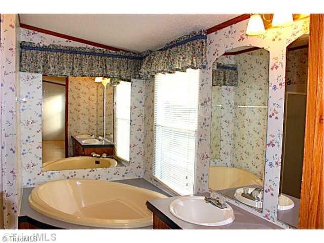 3846 Earnhardt Road Asheboro, NC 27205 - Photo 7 of 10 Master Bath/Spa. The master bath features a separate tub and shower, and double sinks.