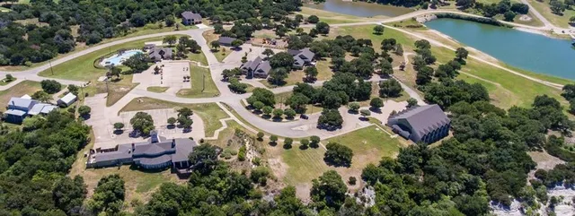 an aerial view of residential house with outdoor space and swimming pool