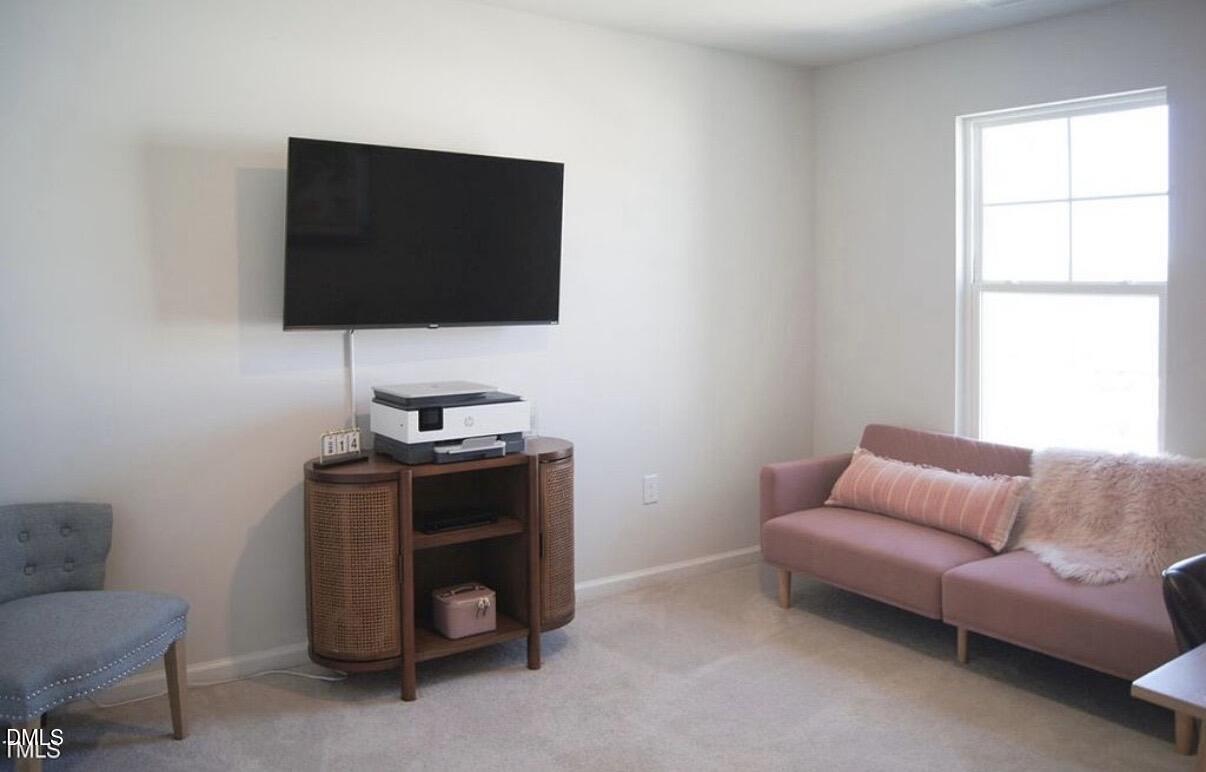 5006 Tura Street Raleigh, NC 27610 - Photo 24 of 32 a living room with furniture and a flat screen tv
