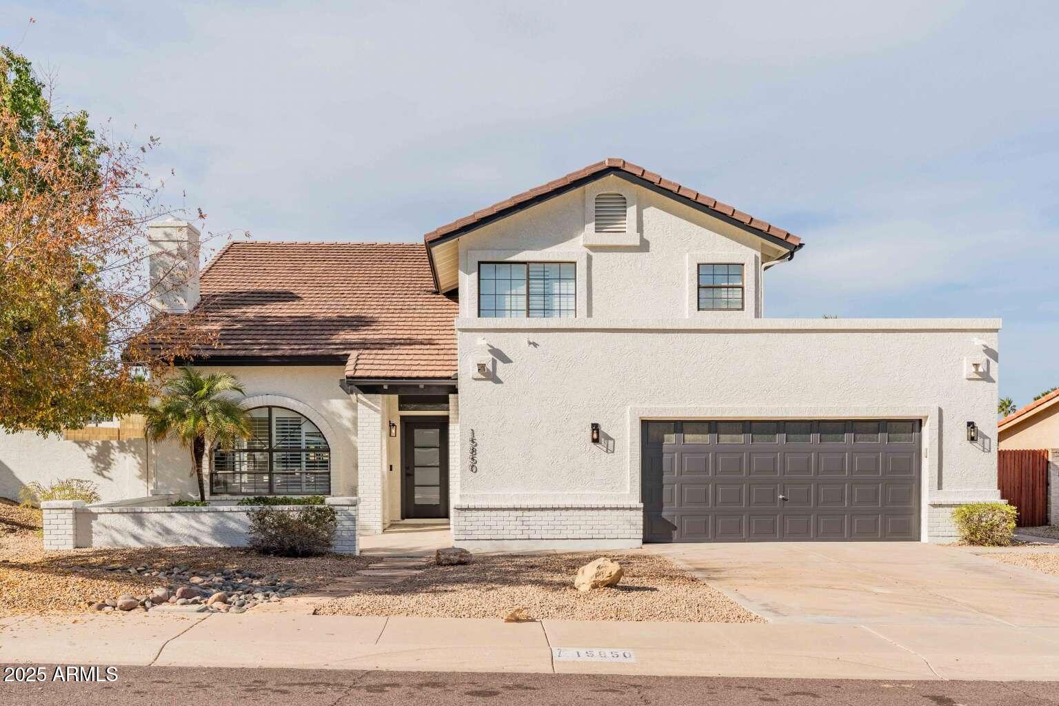 15850 North 15th Way Phoenix, AZ 85022 - Photo 1 of 43 a front view of a house with a yard and garage