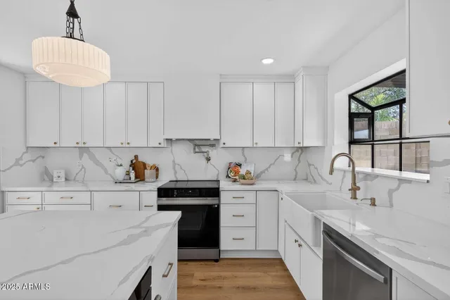 a kitchen with a sink dishwasher a stove a microwave and cabinets