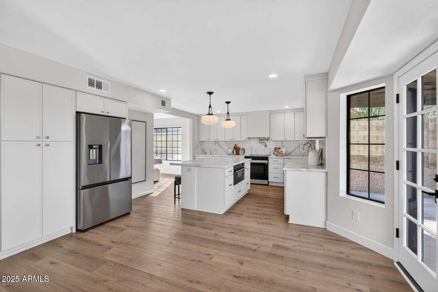 15850 North 15th Way Phoenix, AZ 85022 - Photo 12 of 43 a kitchen with stainless steel appliances granite countertop a refrigerator and a stove top oven