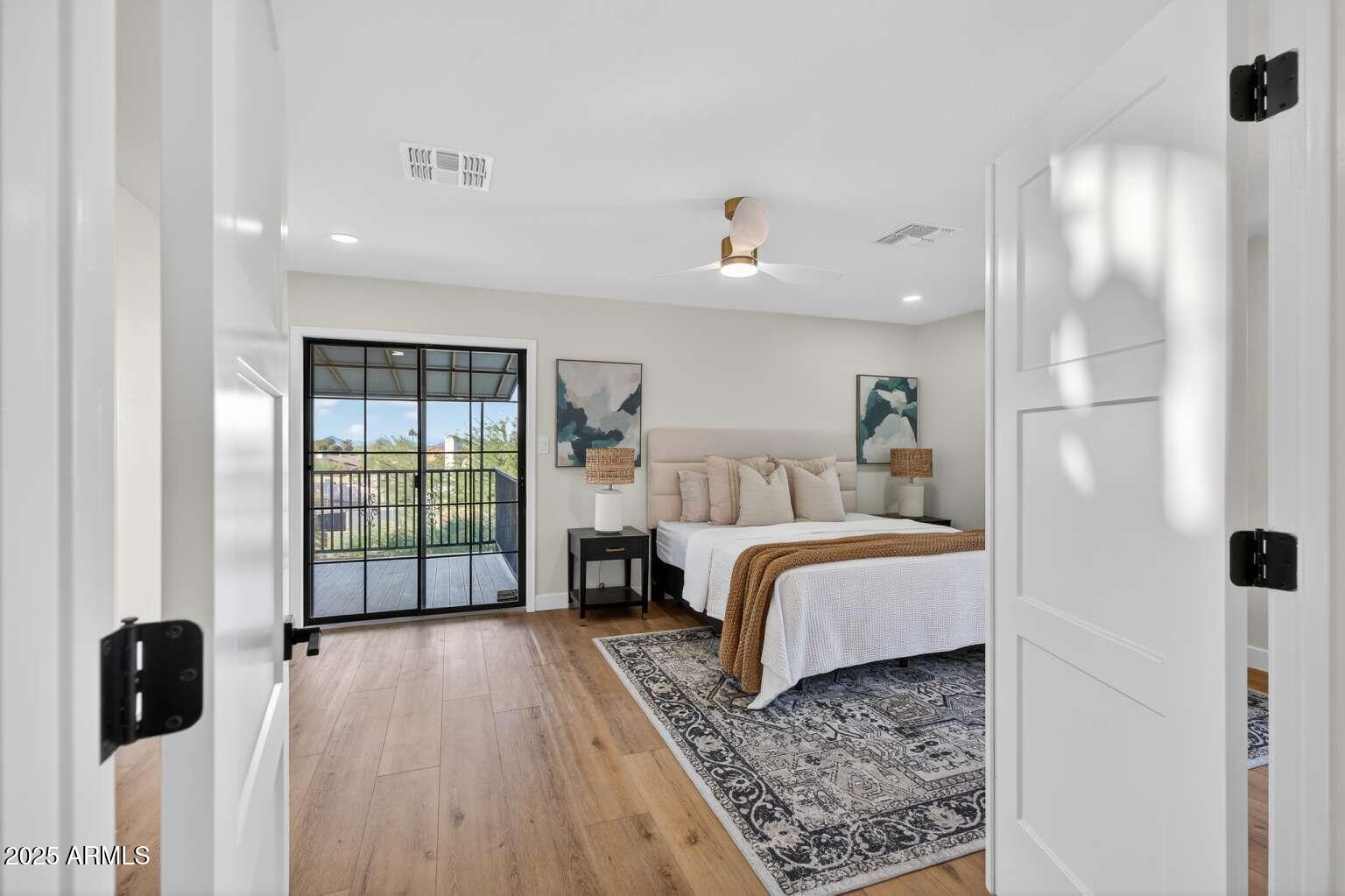 15850 North 15th Way Phoenix, AZ 85022 - Photo 19 of 43 a bedroom with a bed and large window