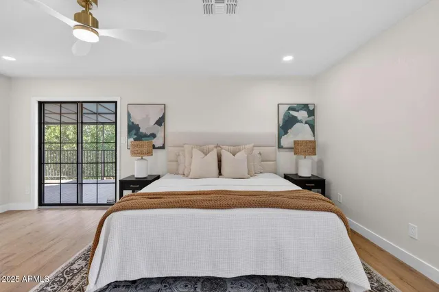 a bedroom with a bed and a large window