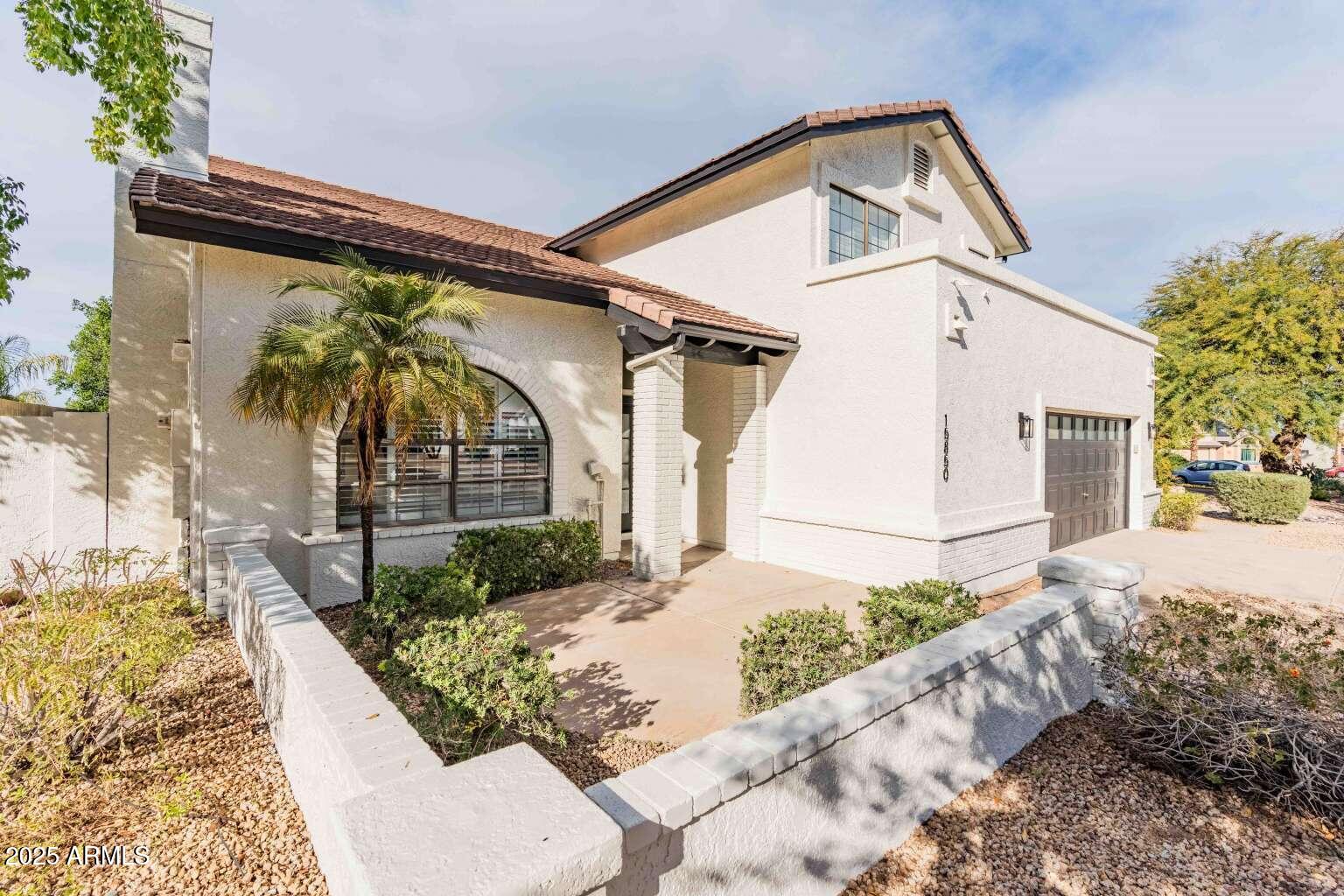 15850 North 15th Way Phoenix, AZ 85022 - Photo 2 of 43 a front view of a house with garden