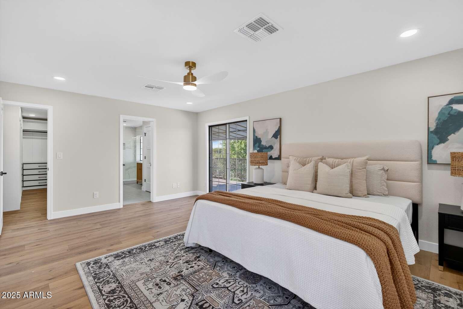 15850 North 15th Way Phoenix, AZ 85022 - Photo 21 of 43 a bedroom with a large bed and a chandelier