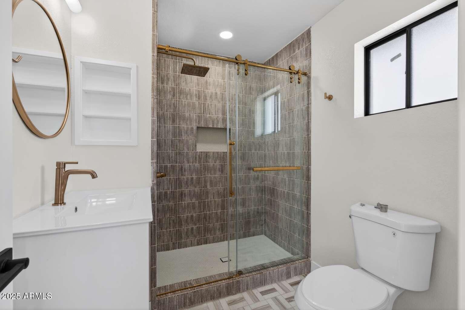 15850 North 15th Way Phoenix, AZ 85022 - Photo 37 of 43 a bathroom with a shower a toilet and a sink