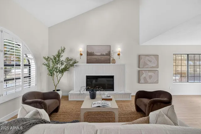 a living room with furniture and a fireplace