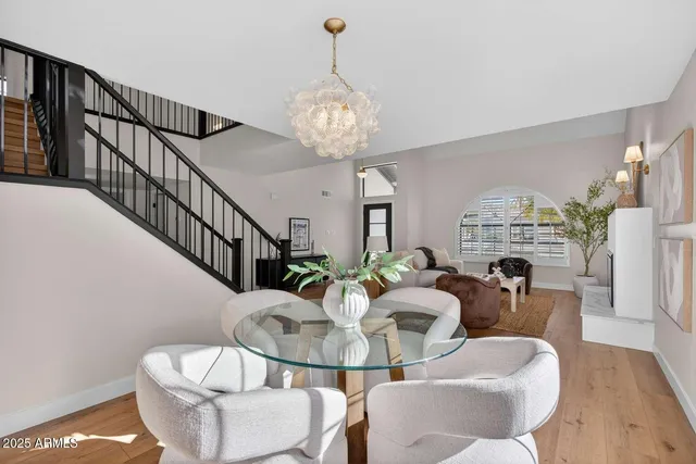 a view of a dining room with furniture wooden floor and chandelier