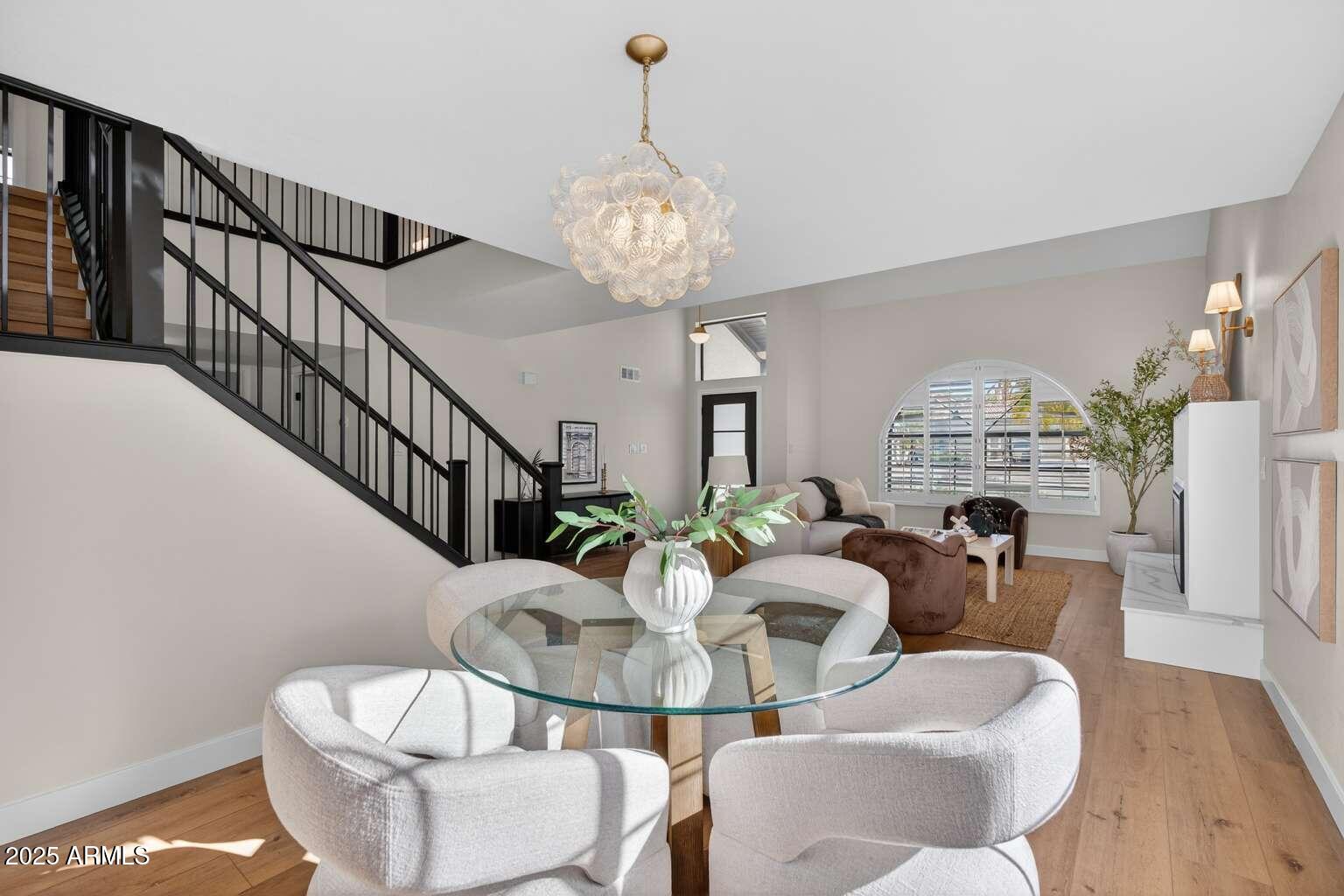 15850 North 15th Way Phoenix, AZ 85022 - Photo 8 of 43 a view of a dining room with furniture wooden floor and chandelier