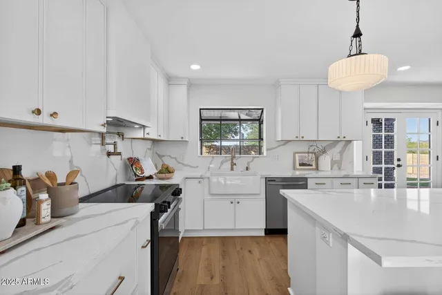 a kitchen with cabinets a sink and appliances
