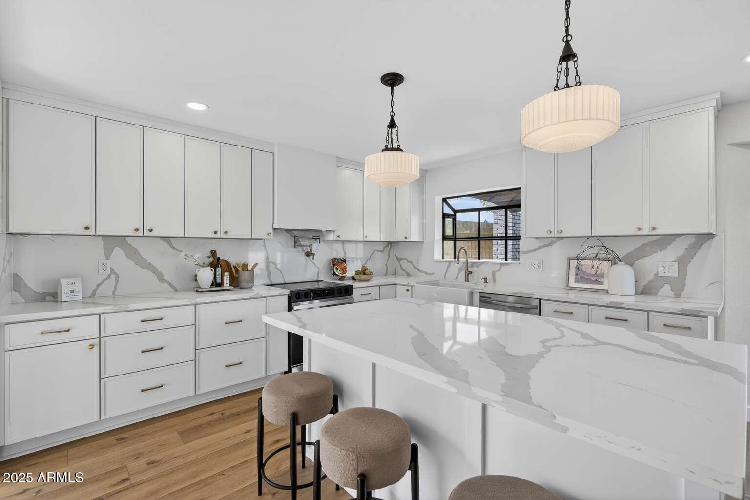 15850 North 15th Way Phoenix, AZ 85022 - Photo 10 of 43 a kitchen with granite countertop white cabinets and chairs