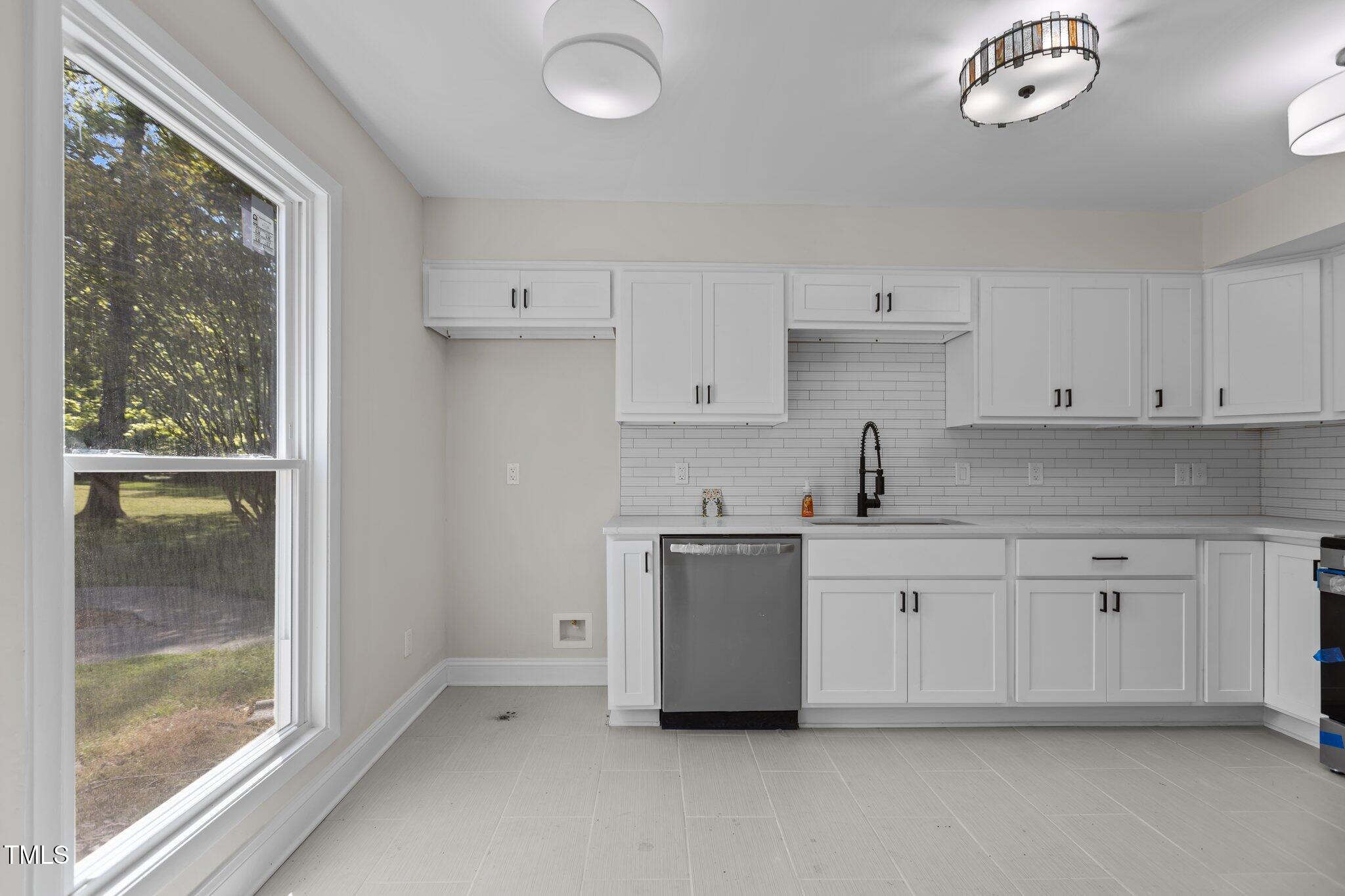 1304 Seaton Road, Unit 24 Durham, NC 27713 - Photo 9 of 38 a kitchen with white cabinets and a sink