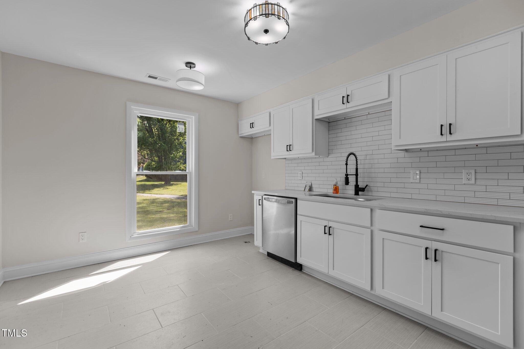 1304 Seaton Road, Unit 24 Durham, NC 27713 - Photo 13 of 38 a kitchen with cabinets a sink and appliances