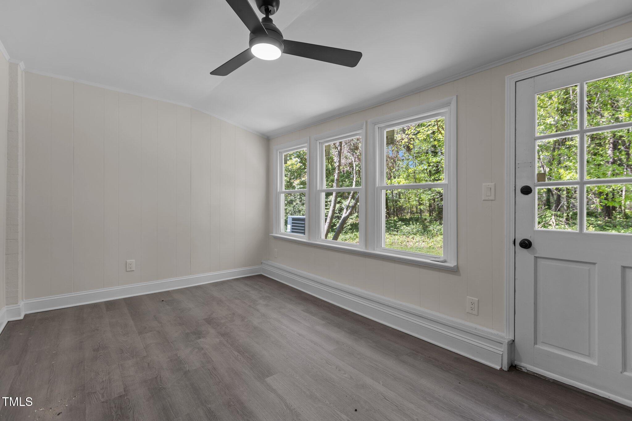 1304 Seaton Road, Unit 24 Durham, NC 27713 - Photo 21 of 38 a view of an empty room with a window and wooden floor