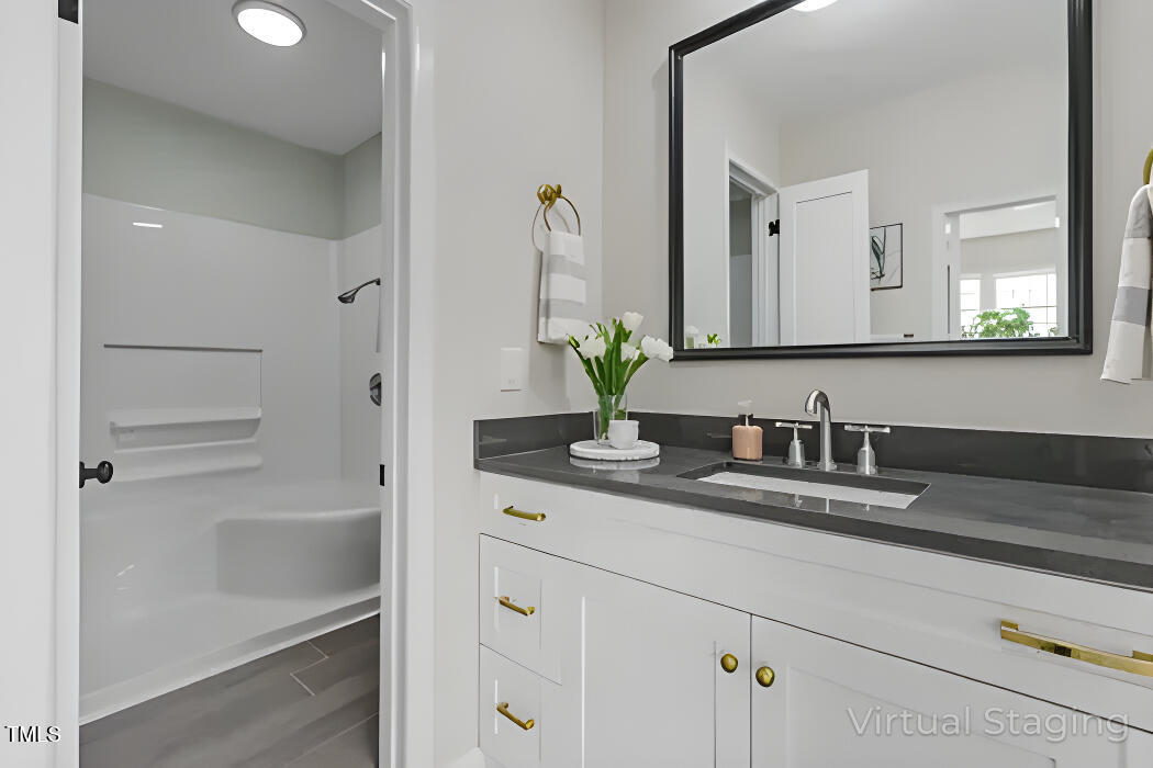 1304 Seaton Road, Unit 24 Durham, NC 27713 - Photo 28 of 38 a bathroom with cabinets and mirror