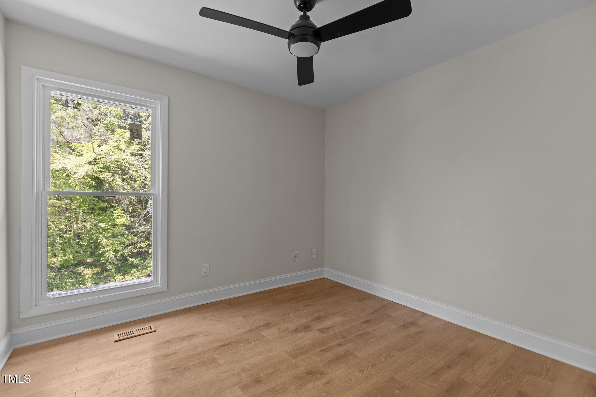 1304 Seaton Road, Unit 24 Durham, NC 27713 - Photo 30 of 38 a room with a window and a ceiling fan