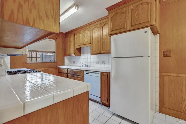 a kitchen with stainless steel appliances granite countertop a stove and a microwave