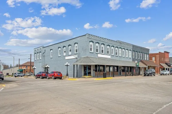 a front view of building with cars parked