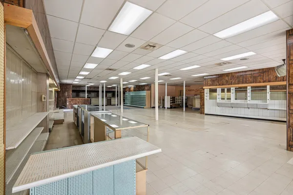 a view of a kitchen with a sink a counter top space