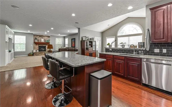 a view of a dining room with furniture a chandelier and wooden floor