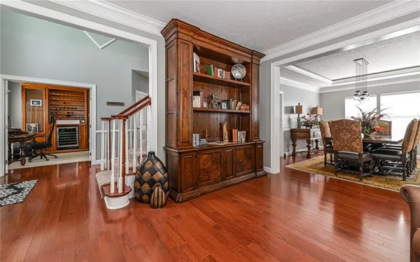 a dining room with furniture a chandelier and wooden floor