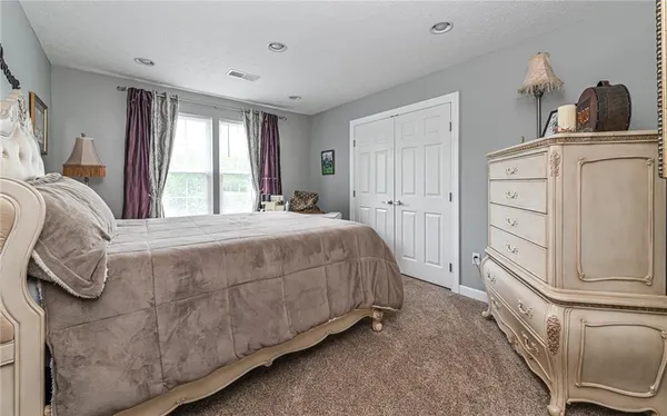 a bathroom with a sink toilet a mirror and shower