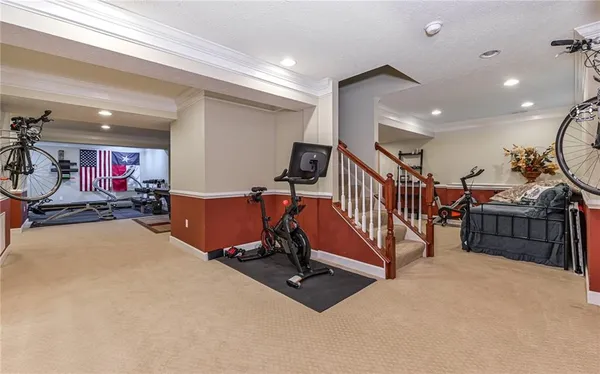 a living room with furniture pool table and chairs