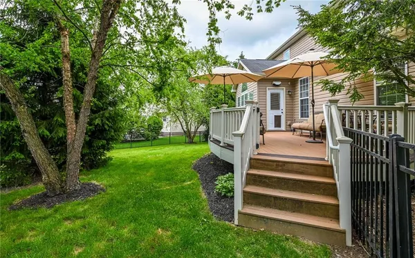 a view of a patio with a table and chairs under an umbrella