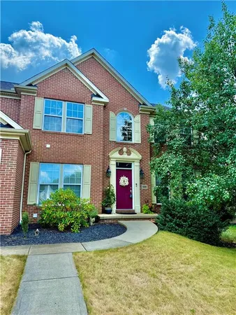 a front view of a house with a yard
