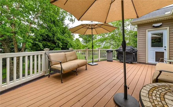 a view of a deck with furniture and wooden deck