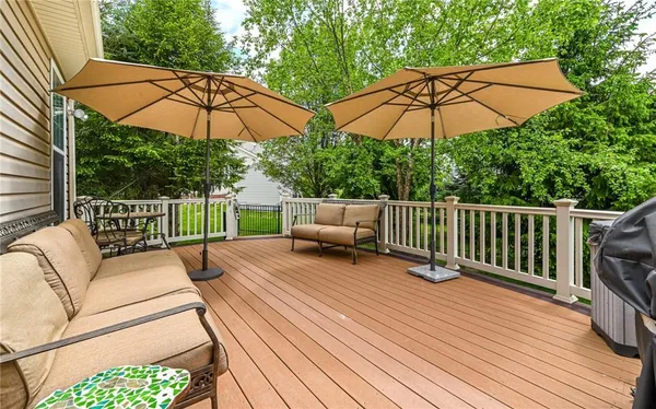 a front view of a house with a garden and deck